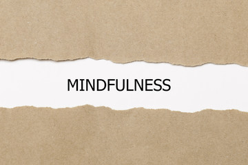 Mindfulness word written under torn paper