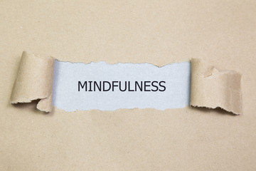 Mindfulness word written under torn paper
