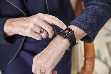 Senior woman checking medical data on smartwatch