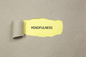 Mindfulness word written under torn paper