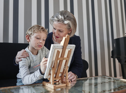 Grandmother and grandson with Dali moustache at easel