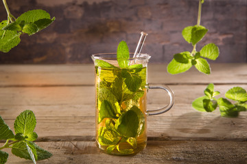 glass of moroccan mint tea and mint leaves