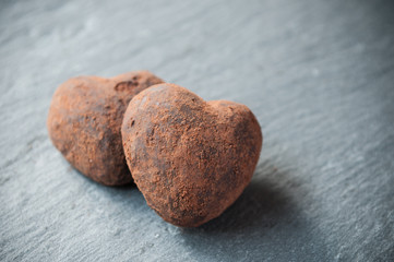 truffes en chocolat en forme de coeur sur un fond en ardoise