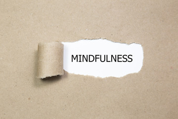 Mindfulness word written under torn paper