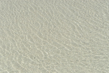 watery texture with sand background  in the Xpu-Ha beach on the beach of the Caribbean sea of Mexico