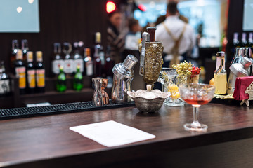 Set of bar accessories and ingredients for making a cocktails on counter.