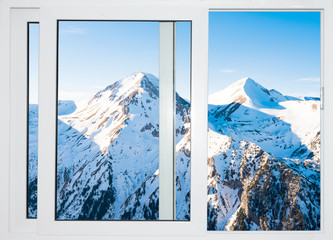white windows with views of the peaks of snowy mountains