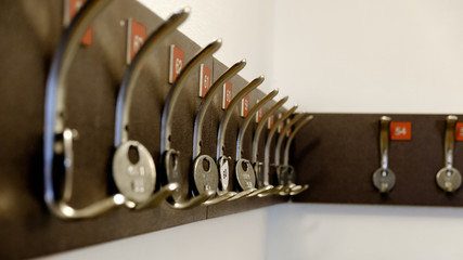 Hooks for clothes with numbers in the locker room.