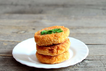 Fried vegetarian patties on a plate isolated on wooden background. Tasty patties made with boiled dried peas, eggs, flour and spices. Vegetarian food idea. Closeup