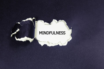Mindfulness word written under torn paper