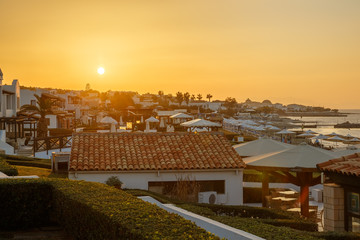 Fototapeta na wymiar Greek hotel on the Aegean Sea, on the background of sunset sky