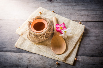 clay pot in sack bag and wooden spoon
