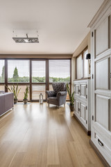 Room with armchair and cabinets