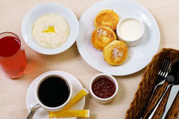 Set table with porridge cheesecakes coffee in cafe