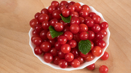 Cherry in a bowl on the table.