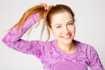 Fototapeta premium young smiling woman straightens her hair