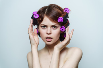 woman with purple hair curlers on her head