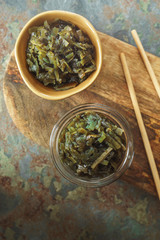 Seaweed in bowls on a wooden board on the table