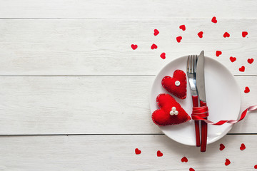 Festive table setting for Valentine's Day with fork, knife and h