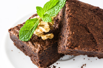 Chocolate brownie pieces isolated on white background
