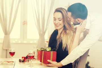Man gives a woman a gift on New Years Eve