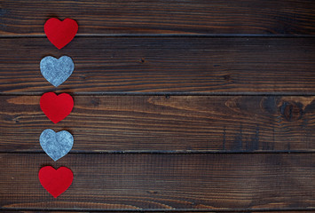 Fototapeta premium Hearts on a wooden background. The concept of Valentine's Day