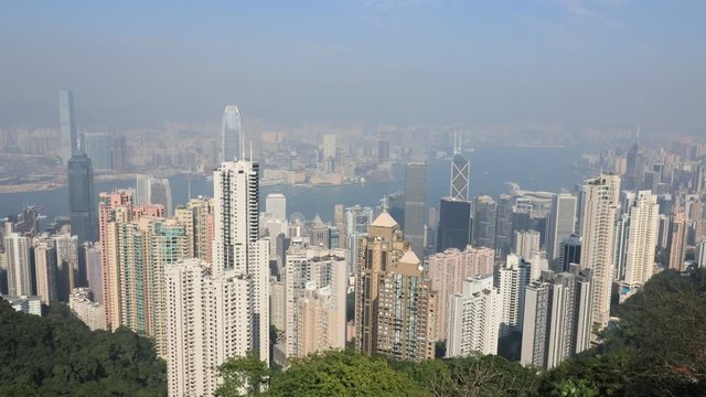 Aerial view time lapse of Victoria Harbour skyline from Sky Terrace 428, the viewing platform on top of the Peak Tower, icon building in Hong Kong.