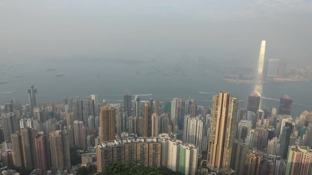 Aerial view time lapse of Victoria Harbour and skyscrapers from Lugard Road Lookout, most photographed panoramic point within the Peak Circle Walk. The Victoria Peak, the highest mountain in Hong Kong