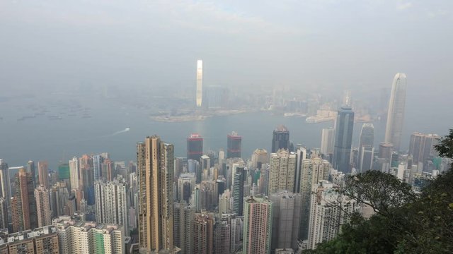 Aerial view time lapse of Victoria Harbour and skyscrapers from Lugard Road Lookout, most photographed panoramic point within the Peak Circle Walk. The Victoria Peak, the highest mountain in Hong Kong