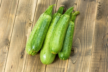 Green zucchini on wooden board