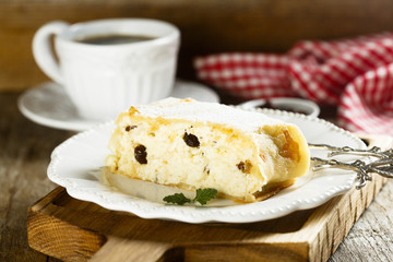 Homemade strudel with cottage cheese, apples and raisins