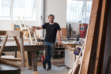 Environmental portrait of a furniture designer maker in his work