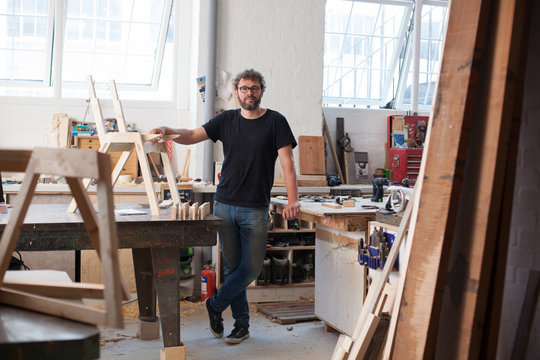 Environmental Portrait Of A Furniture Designer Maker In His Work