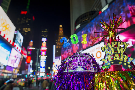 Colorful 2017 Happy New Year message with celebration tinsel flying on novelty party hats in Times Square, New York City