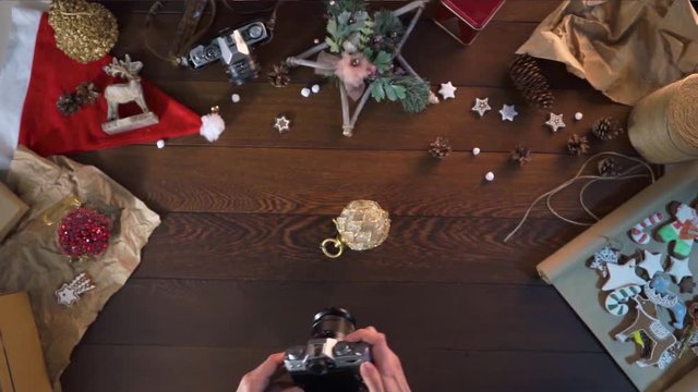 woman takes a picture in the camera. Christmas tree toy. decorations for the New Year. Christmas gingerbread. gifts for family