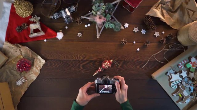 woman takes a picture in the camera. Christmas tree toy. decorations for the New Year. Christmas gingerbread. gifts for family