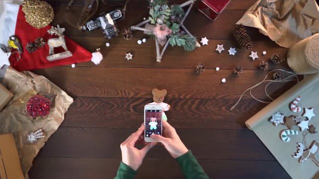 woman takes a picture to your phone. cakes in the form of various figures. sweet gift cookies. decorations for the New Year. Christmas gingerbread. cookies in the shape of a bear