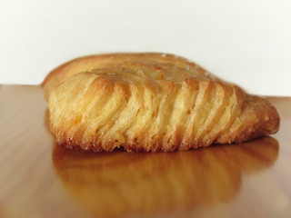 Brioche on a wooden table with granulated sugar garnish . Italian breakfast
