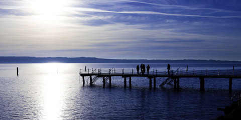 Fototapeta na wymiar Pier with people silhouette