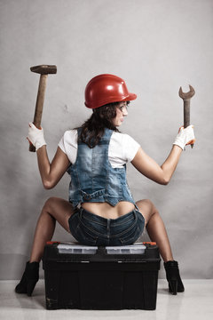Sexy girl mechanic working with tools. Back.