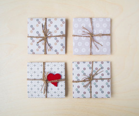 Rustic handmade gift boxes over wooden background. Top view, flat lay