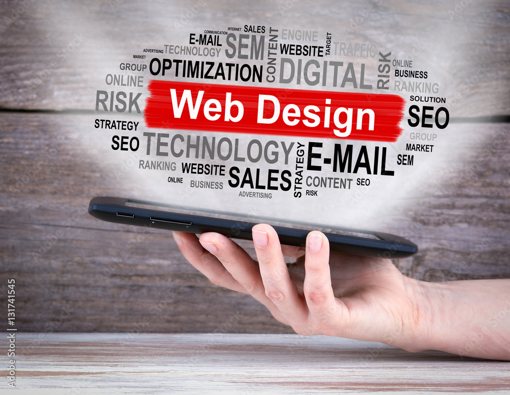 Sticker web design concept. tablet computer in the hand. old wooden background.