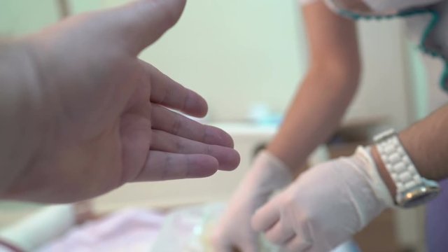 Patient POV from hospital bed. Finger prick blood test