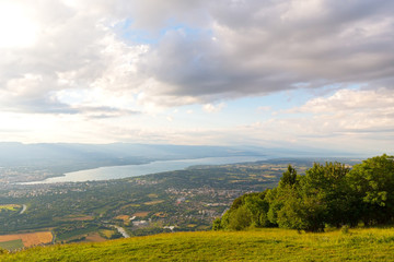 Fototapeta na wymiar Panoramic view of Geneva city and Lake Geneva from the mountains. Swiss Alps surrounding the city of Geneva provide beautiful views of the lake.