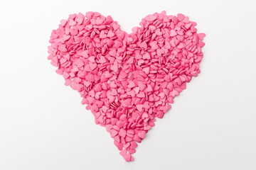 pink heart made of many smaller hearts on a white background. festive background for Valentine's day, birthday, holiday