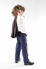 Little curly businessman stands with his back to the camera, throwing his jacket over his shoulder and looking at the camera. White background.