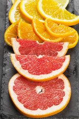 Fototapeta na wymiar Various citrus - orange, lemon, tangerine, grapefruit on a dark