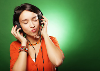 Young   woman with headphones listening music 