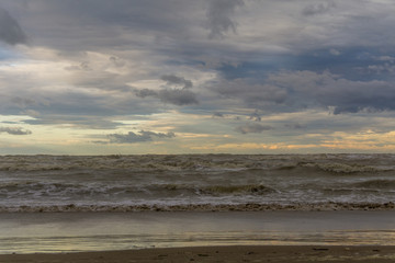 sea and beach with clouds. Rough sea