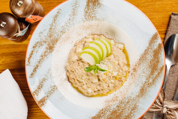 oatmeal with apple and mint in a plate